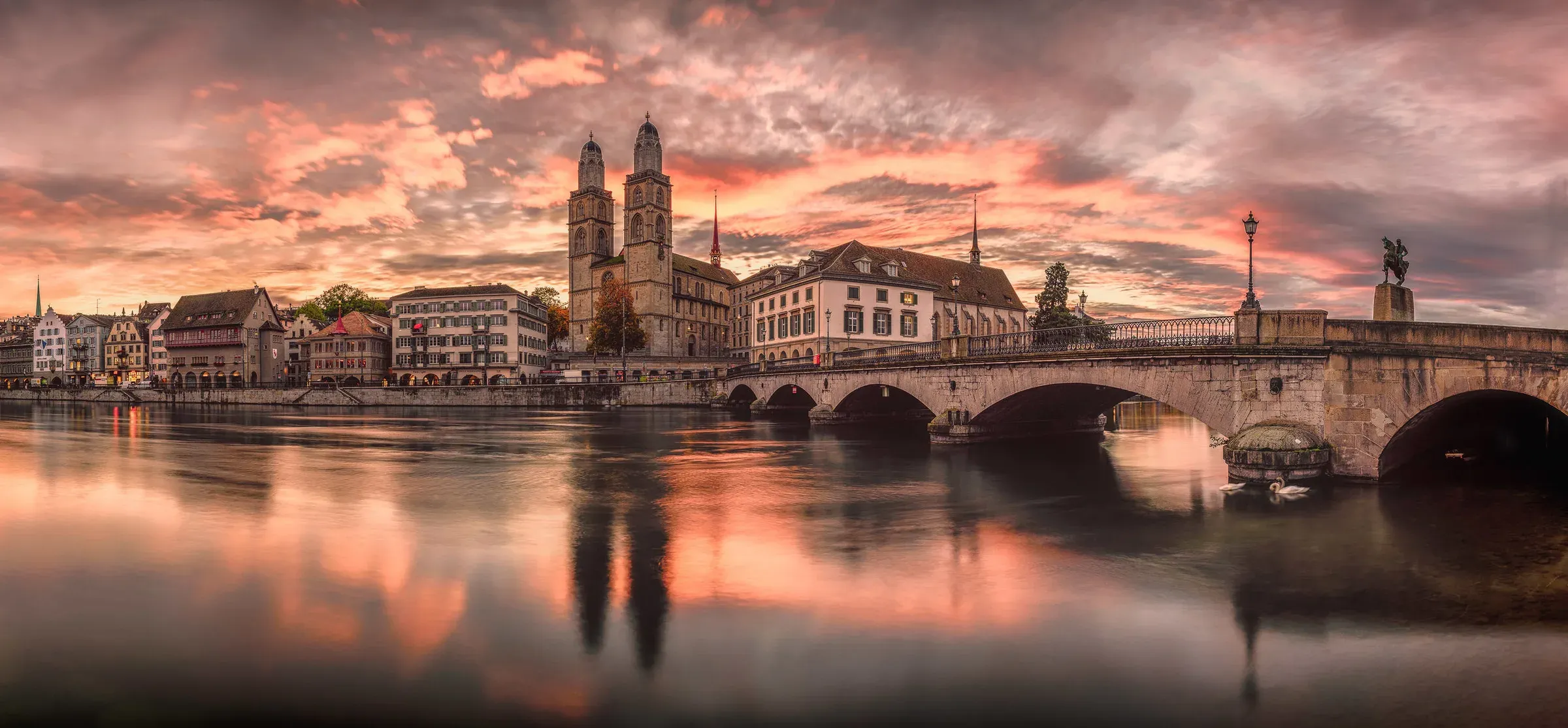 Zurich at sunset — the Limmat, Grossmünster and Münsterbrücke