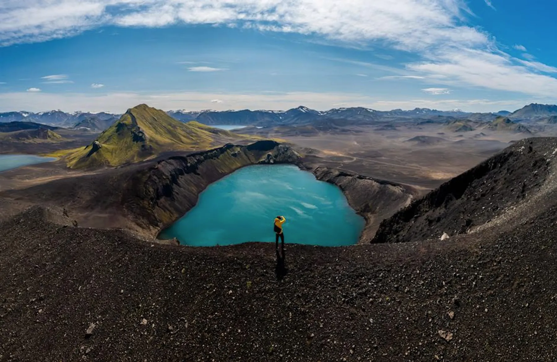 Aerial view of a turquoise volcanic crater lake in the Icelandic Highlands